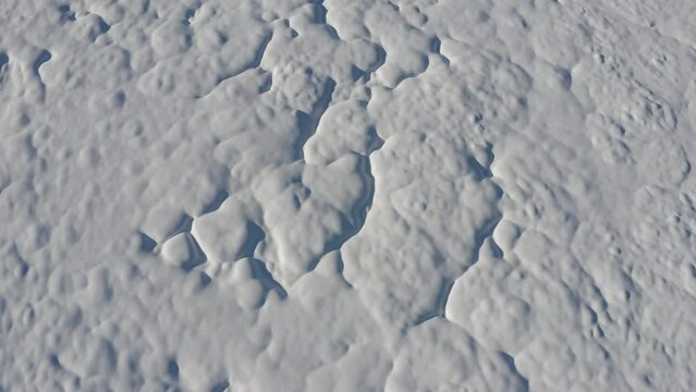 Aerial - Top view of snow covering a forest field. Interesting snow pattern made on top of the soil in a forest field
