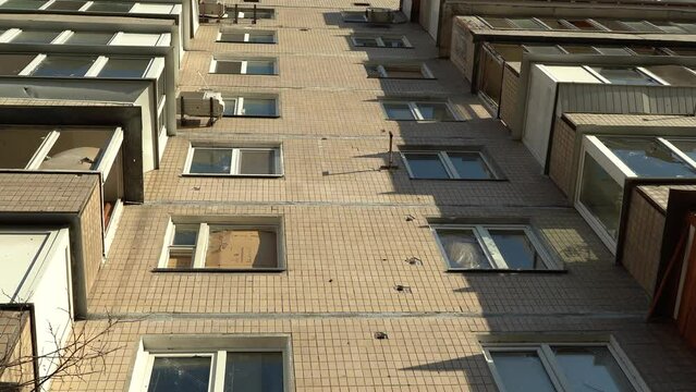 Consequences of rocket attack on the center of Ukraine. Funnel from a drone explosion. Attack of Iranian Shahed 136 drones on Kyiv. Damaged residential building. Broken windows and holes from debris.