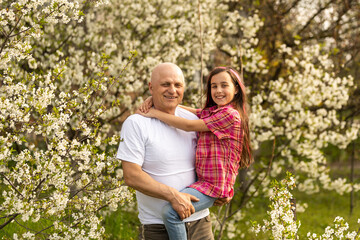 Fototapeta premium grandfather and granddaughter in backyard