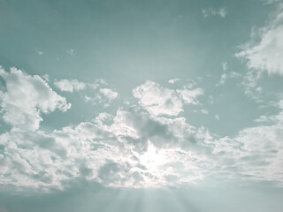 Sun rays passing through the clouds. Abstract sky backdrop. New day sky and sunbeam background.