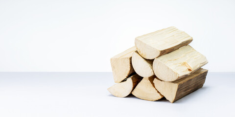 Pile of firewood isolated on white. wooden eco fuel for heating. banner with copy space.