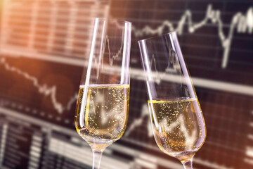Reason to celebrate at the stock exchange. Champagne glasses and monitor with stock market prices...
