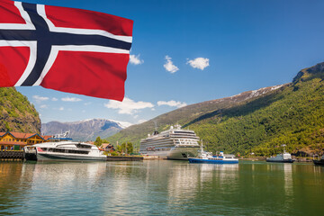 Port of Flam with luxury cruise ship against flag of Norway. - 558365149