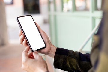 cell phone blank white screen mockup.hand holding texting using mobile on desk at office.background empty space for advertise.work people contact marketing business,technology