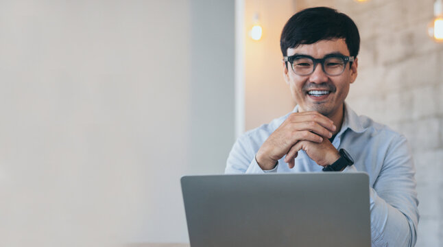 asian man work using computer hand typing laptop keyboard contact us.student study learning education online.adult professional people chatting search at office.concept for technology device business