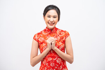Beautiful Asian woman wearing traditional cheongsam with gesture of congratulation isolated on...