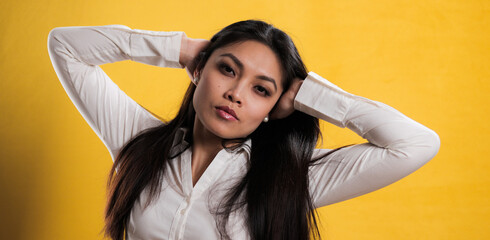 Young pretty woman with Asian appearance posing for the camera - studio photography