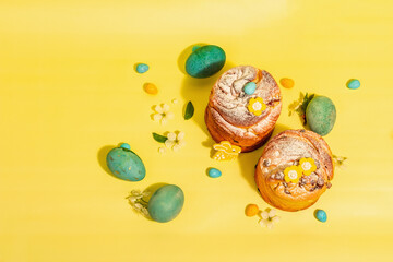 Easter cake Cruffin or sweet bread kulich and traditional painted eggs. Baking and cherry flowers