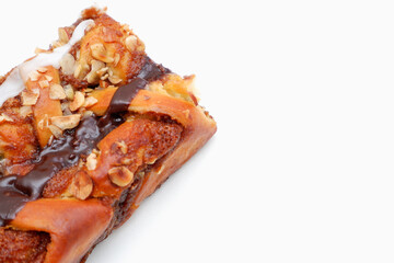 Delicious cake with peanut butter cream layer and chocolate topping. Bakery white background. Selective focus