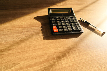 Calculator and pencil with shadow light. Office desk table with supplies. Flat lay Business workplace and objects. Copy space for text
