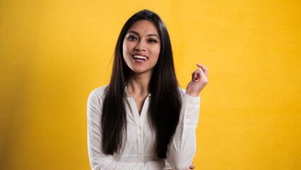 Self-confident satisfied young woman against neutral background - studio photography