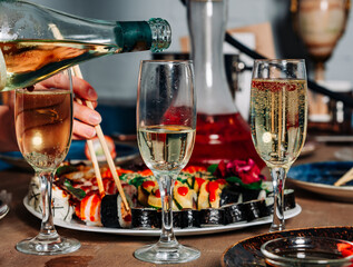 bottle wine or champagne pouring in wine glassin cafe