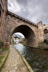 View of a medieval bridge over the river in the village of Potes in Cantabria, Spain. High quality photo