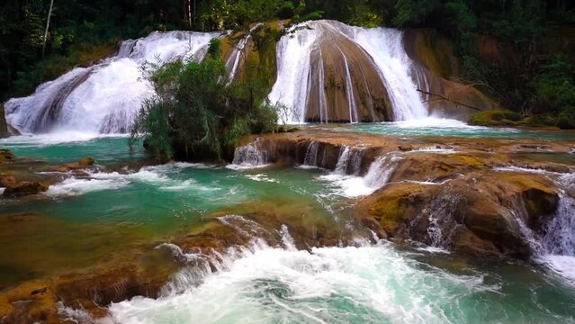 Scenic waterfall in Mexico tropical forest. Beautiful nature. Cascadas Aqua Azul, blue water waterfalls, slow motion