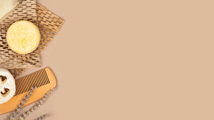 Eco solid shampoo bar and wooden comb laying on a Honeycomb Paper, coffee colored background. Eco friendly hair care. Plastic free, zero waste living, low water ingredients. Copy space