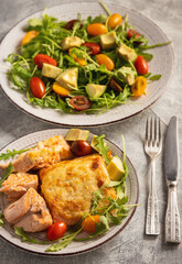 Salmon baked with cheese, served with vegetables.