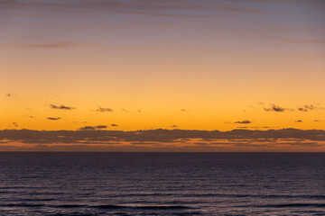 Fototapeta na wymiar Colorful sunrise with clouds over the sea
