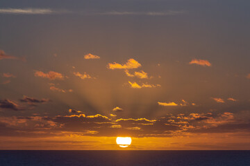 Naklejka na ściany i meble Colorful sunrise with clouds over the sea