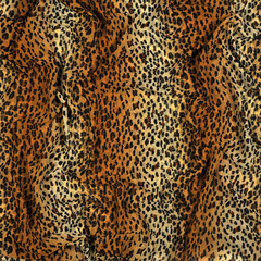 Leopard skin fabric background.  Light silk chiffon  fabric in  yellow- brown leopard colors. top view