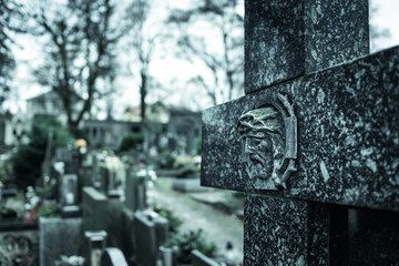 Marble cross in cemetery. Tomb decoration. Memorizing loved ones.