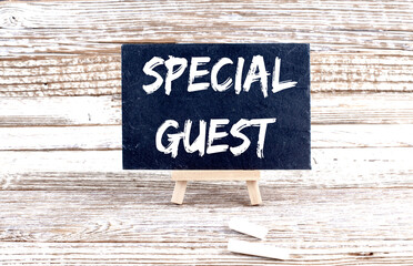 SPECIAL GUEST text on the Miniature chalkboard on wooden background