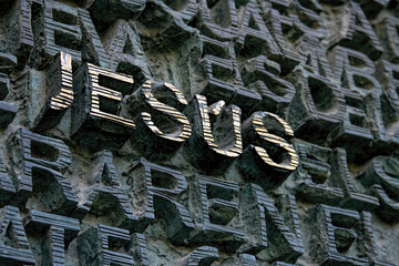 Aged 3D golden letters depiction the name of Jesus.