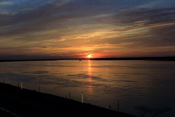 Naklejka na ściany i meble beautiful sunset on the embankment of light yar river volga russia