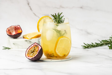 glass of Iced passion fruit soda with lemon and passion fruit half slice on a light background,...