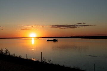 Dry cargo ship on the Volga in the sunset