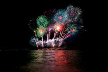 Colorful fireworks of various colors at night with celebration and anniversary concept