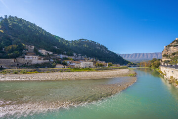 Obraz premium View to Berat, historic city in the south of Albania at night with all lights flashing and white houses gathering on a hill. Captured during blue hour with the sky full of stars.