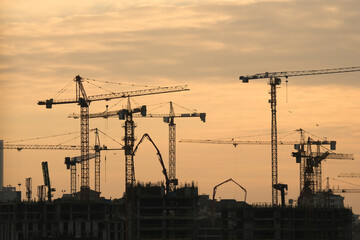 Silhouettes of tower cranes and buildings in a construction site in Istanbul Fikirtepe