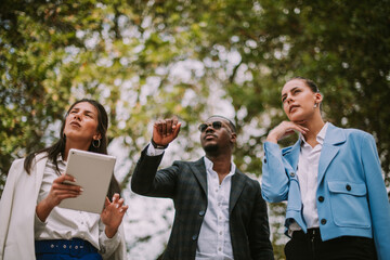 Business man showing something at the park