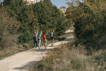 Happy sporty hikers walking and having fun