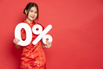 Young Asian woman wearing red traditional cheongsam qipao dress showing 0% number or zero percent...