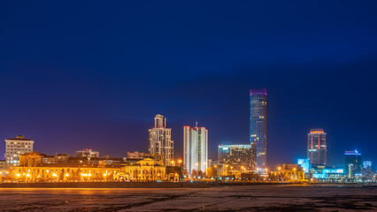 Fototapeta na wymiar Yekaterinburg city with Buildings of Regional Government and Parliament, Dramatic Theatre, Iset Tower, Yeltsin Center, panoramic view at Early Spring night