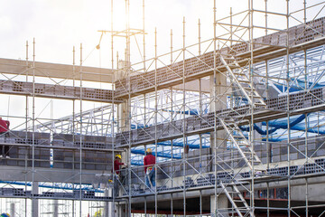 Scaffolding pipe clamp and parts,construction site with scaffold and building strength to scaffold clamps in used on construction site with sunset background,scaffolding for construction factory