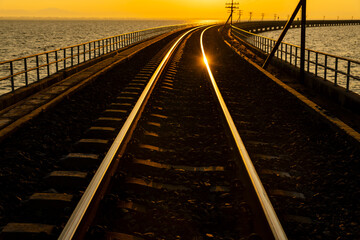 Naklejka na ściany i meble Railroad at sunset. Industrial concept background. Transportation