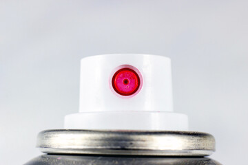Pink acrylic spray paint white plastic cap on a metal can close up on light background with copy space. - 558408337