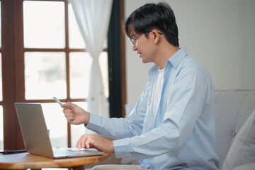 young man using tablet and credit card for online payment, E-commerce.