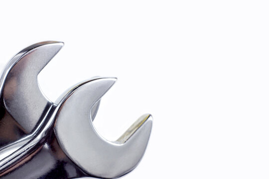 Silver metal wrench for maintenance close up on white background with copy space.