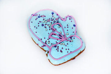 Gingerbread cakes for the new year on a white background. Green and blue sweet gingerbread cakes with icing.