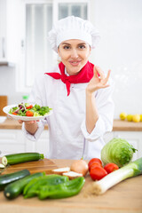 Female chef with plate of vegetable salad