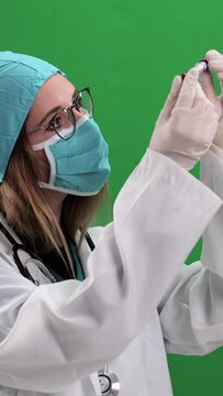 Female doctor examines a blood sample - studio photography - Vertical video