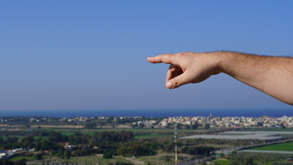 Tour guide's hand pointing to some object