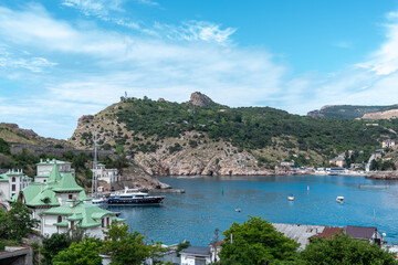 Obraz premium Aerial panoramic view of Balaklava bay in Crimea, mountain cliffs and sea with ships. Beautiful nature panorama landscape