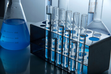 microscope with lab glassware, science laboratory research and development concept