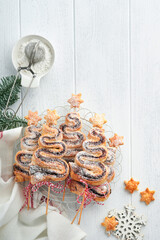 Christmas tree shape puff pastry cakes with chocolate filling, sugar powder and lollipops on old...