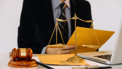 Business and lawyers discussing contract papers with brass scale on desk in office. Law, legal...