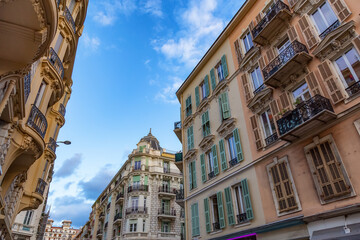 Fototapeta na wymiar Old Architecture Apartment homes in Downtown Nice, France. Sunny Cloudy Day.